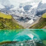 Turquoise glacial Humantay Lake surrounded by snow-capped Andean peaks (humantay lake) | Viajes Peru Tour