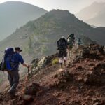 Hikers trekking on a mountain trail in the Peruvian Andes (best month for inca trail) | Viajes Peru Tour
